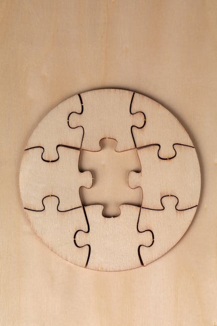 Round wooden puzzle with missing piece on a wooden background, top view.